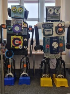 Two robot statues standing side by side