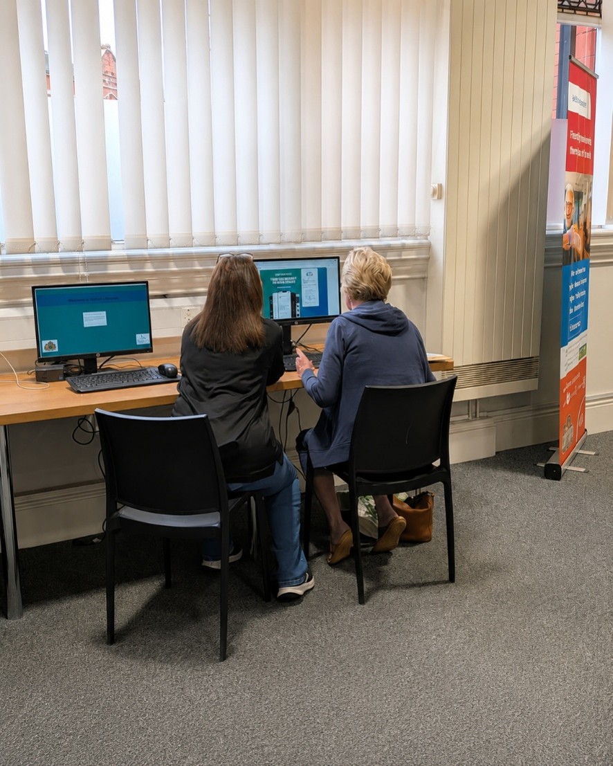 Staff member helping library user