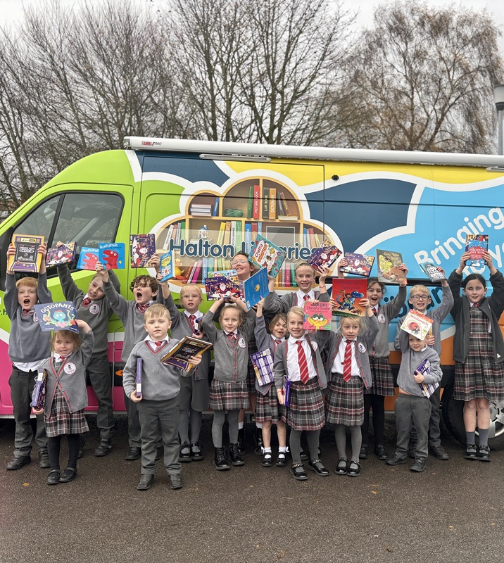 Happy school children showing off their books