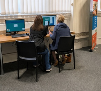 Library staff helping library user