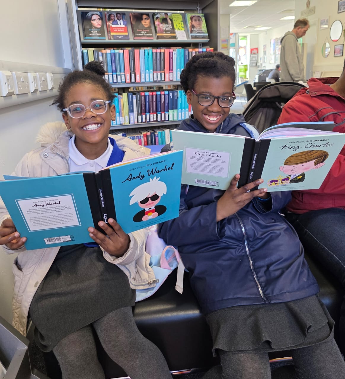 Smiling school children reading